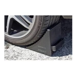 Wheel chock placed against truck tyre at loading bay